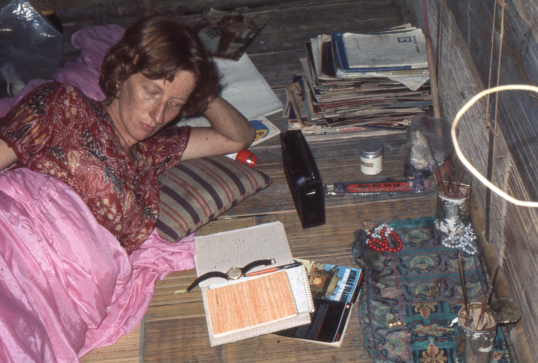 Sue in the Malaysian jungle in the early 1970s, surrounded by notebooks, papers and everyday objects