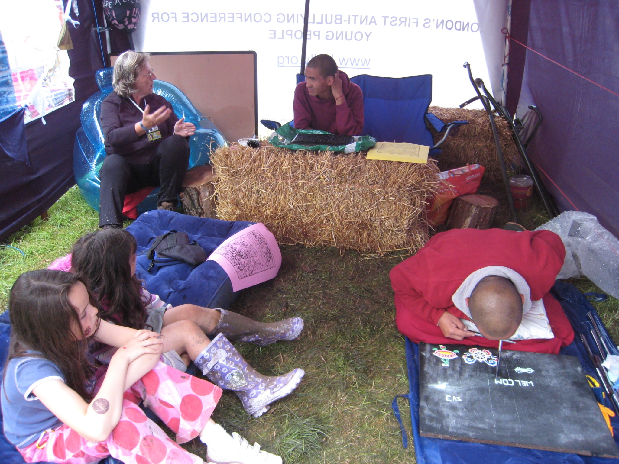 Sue discussing ritual with monks at Glastonbury Festival