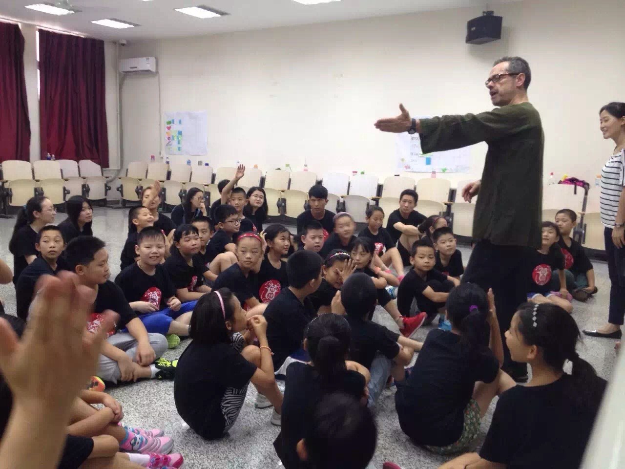 Andy facilitating a workshop with a large seated group in China