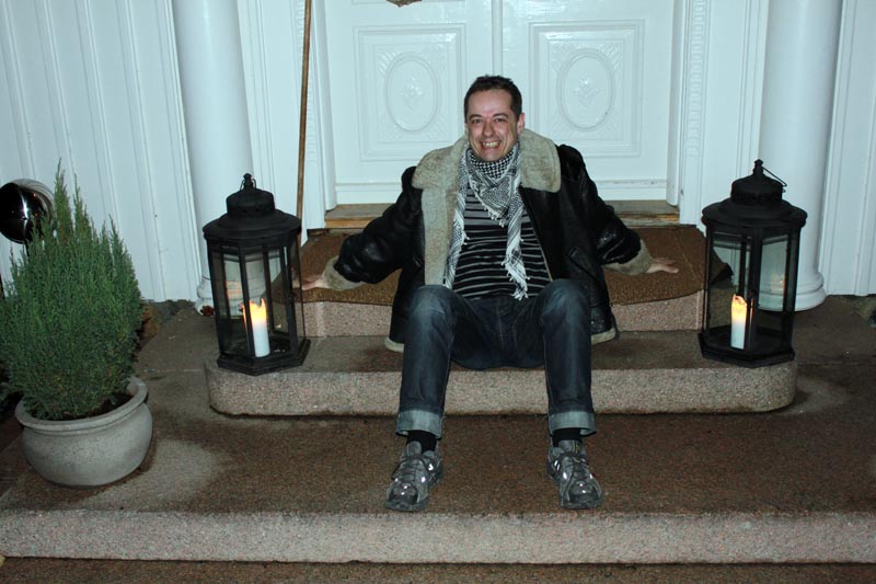 Andy sitting on the steps outside a workshop venue in Norway