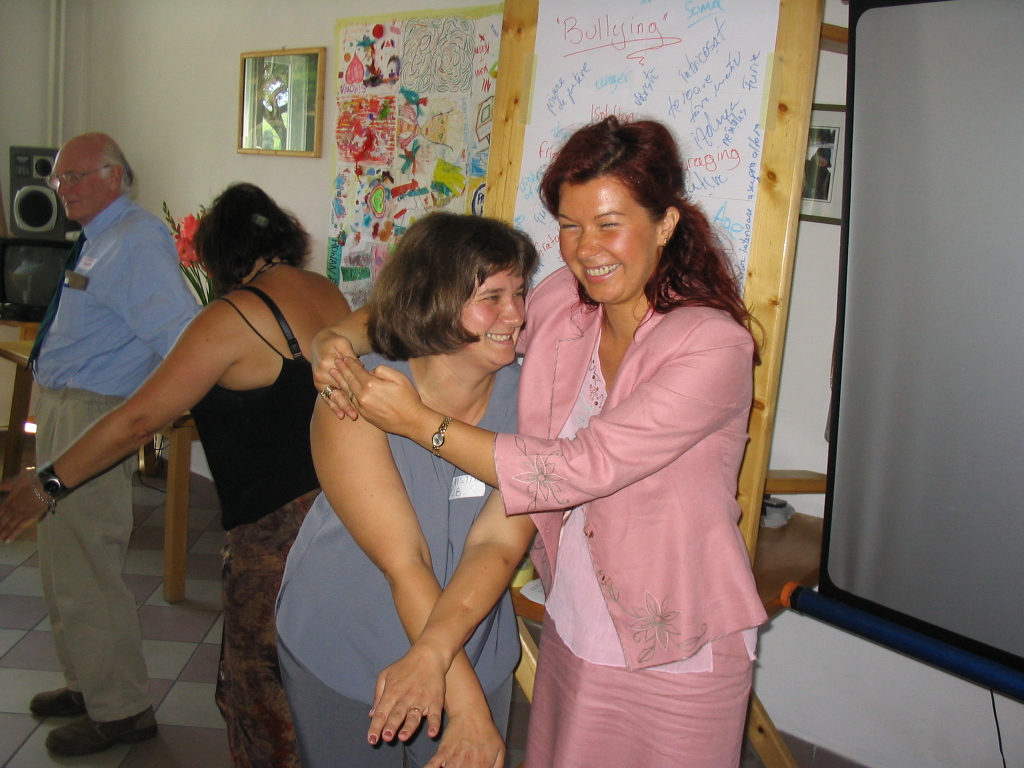 Two adults enjoying a playful moment at a workshop