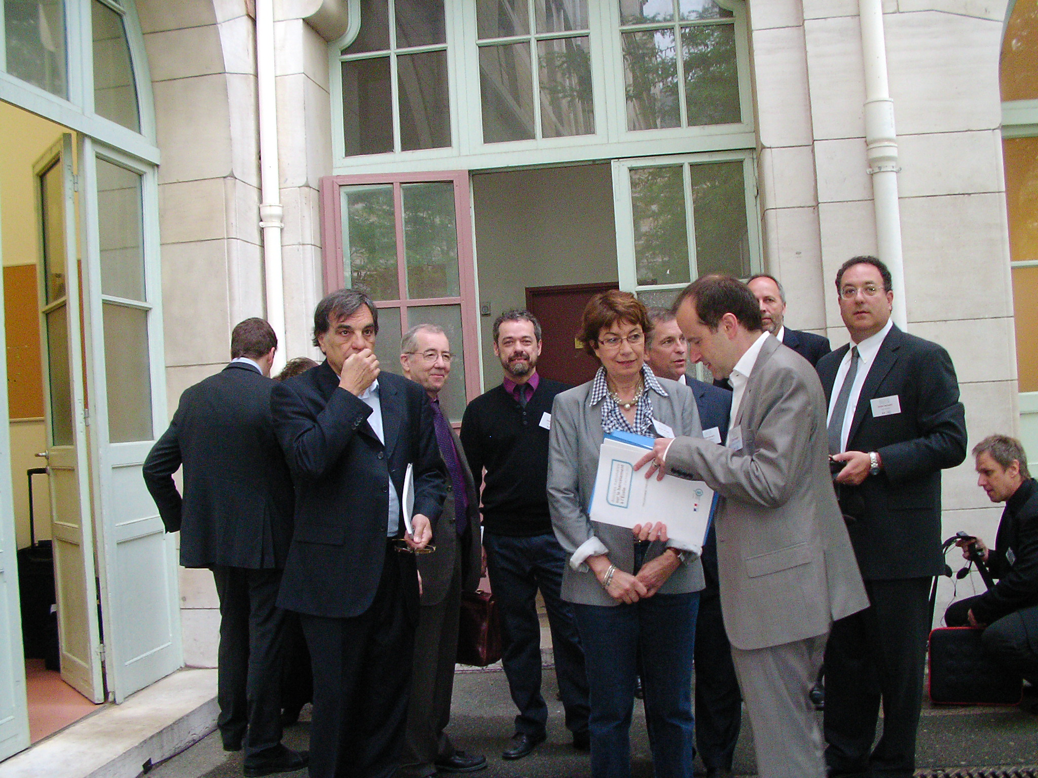 Participants gathered outside a building after a meeting