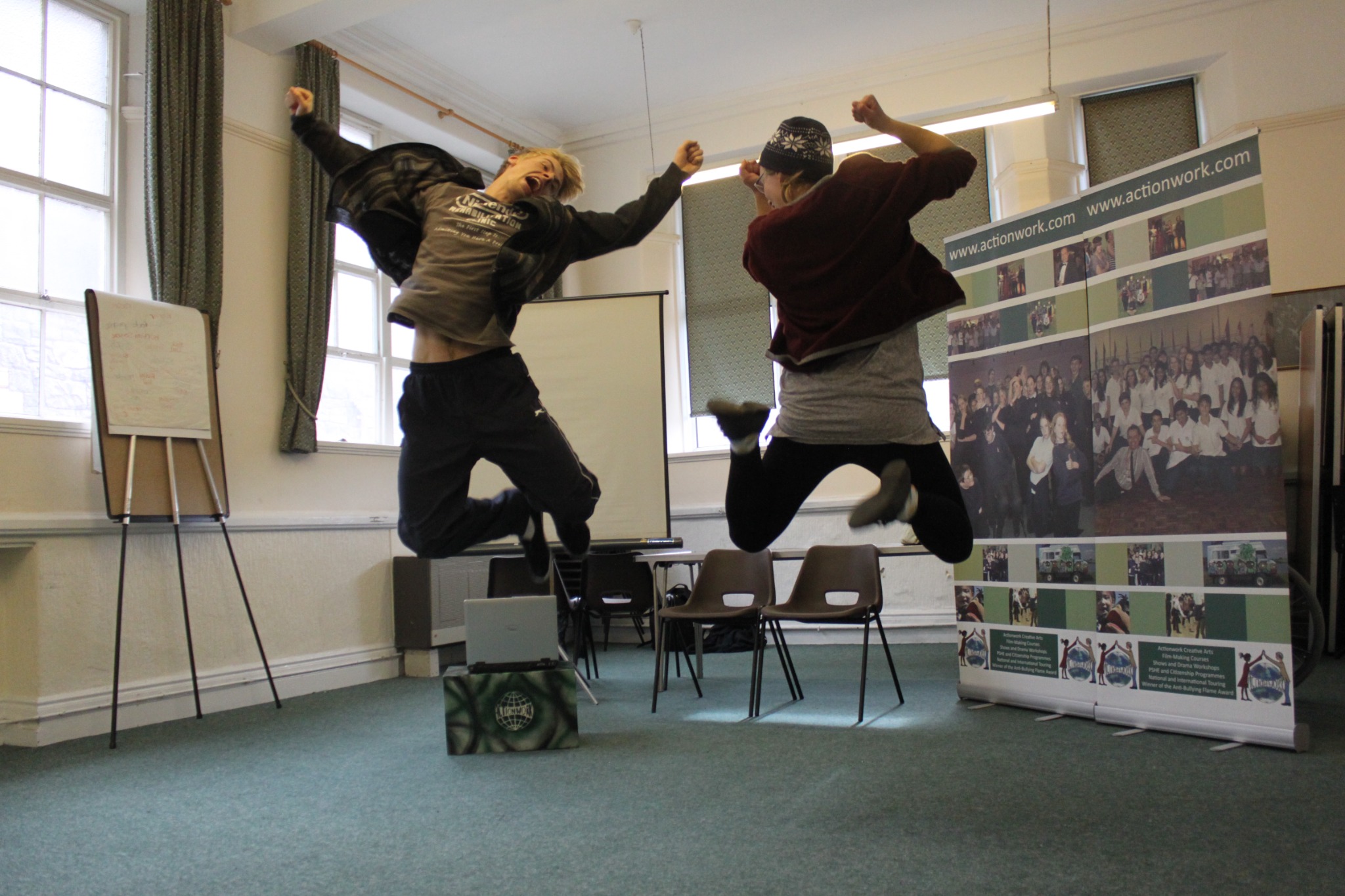 Two performers jumping during an anti bullying roadshow session